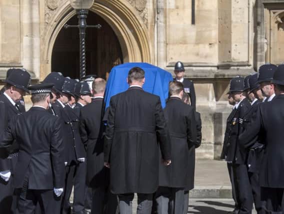 The coffin of Pc Keith Palmer passes a police guard of honour as it arrives at Westminster's Chapel of St Mary Undercroft