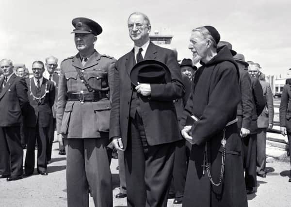 Eamon de Valera, centre, worked closely with the Catholic Church to formulate the 1937 constitution. He is seen here visiting Shannon airport in the 1960s.