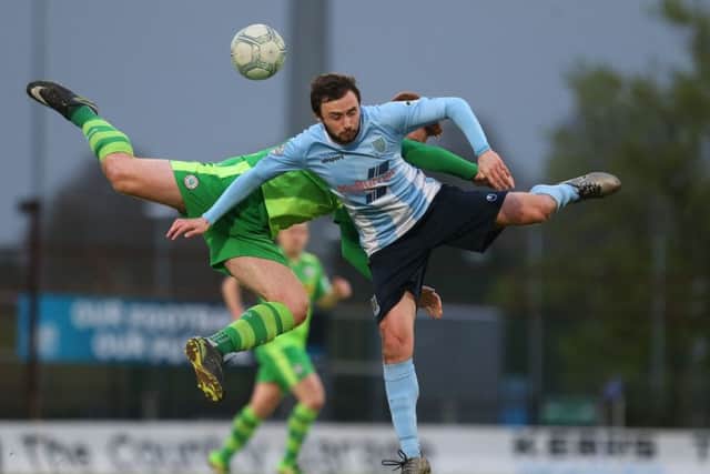 Ballymena United's Francis McCaffrey in action with Cliftonville's Stephen Garrett