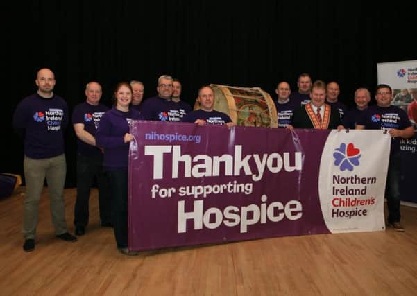 Members of Bible and Crown Defenders LOL 423, who are climbing the UK's highest peaks in aid of the NI Children's Hospice. Also pictured are Deputy Grand Master, Harold Henning, and charity representative, Jenay Doyle