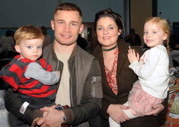 Carl Frampton MBE pictured with his wife Christine and their children Carla and Rossa