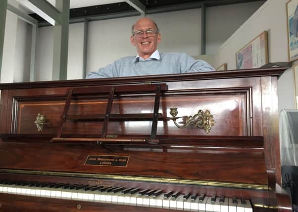 Tuner Martin Backhouse at Ludlow Museum with the piano where he found a stash of gold, as a mystery surrounds the identity of the rightful heirs to a treasure trove of gold coins worth enough to buy a house which were found hidden under an old piano's keyboard. PRESS ASSOCIATION Photo. Picture date: Thursday April 20, 2017. The 913 coins, found neatly stacked in dusty hand-stitched packages and pouches, were discovered carefully secreted beneath the instrument's keyboard base while it was being re-tuned. See PA story INQUEST Piano. Photo credit should read: Richard Vernalls/PA Wire