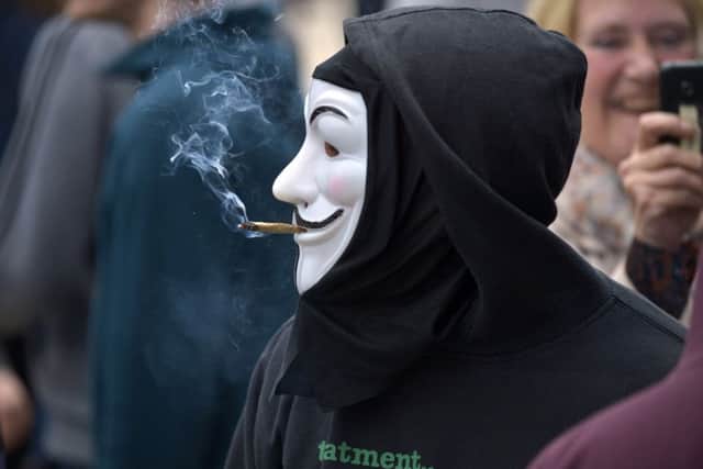 A man smoking a joint at the LegenDerry Cannabis Club 4/20 cannabis smoke out protest, in Guildhall Square