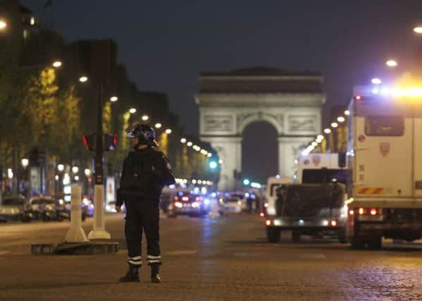 A police officer stands guard after a fatal shooting on the Champs Elysees in Paris, France.