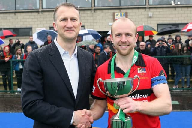 Eugene Magee collects the trophy from Michael Kidd from sponsors EY. Pic: Freddie Parkinson / Press Eye