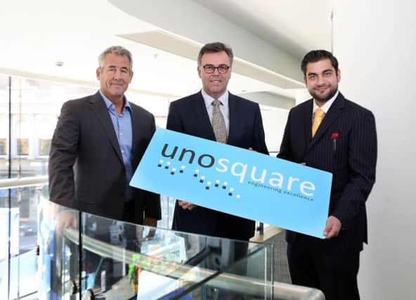Unosquare CEO Mike Barrett and president Giancarlo Di Vece, left and right, with Invest NI CEO Alastair Hamilton