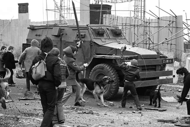 Youths bombarding an Army Saracen at junction on Whiterock Road in November 1980.