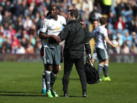 Manchester United's Paul Pogba leaves the field of play with an injury during the Premier League match at Burnley.