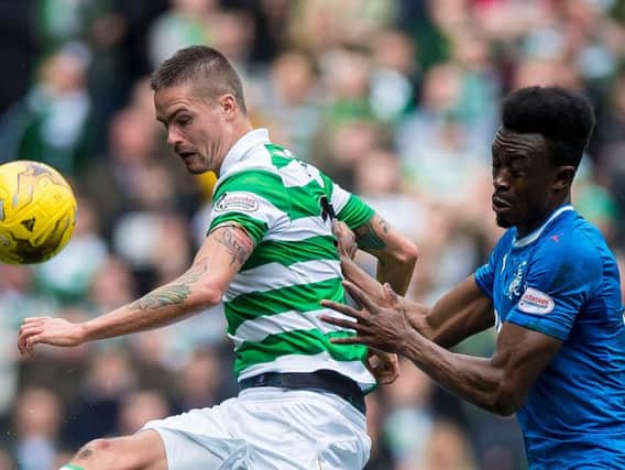 Celtic's Mikael Lustig and Rangers' Joe Dodoo compete for the ball