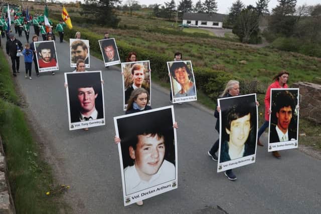 Marchers hold photographs of the eight IRA members and bystander Anthony Hughes who were killed in an SAS ambush in Loughgall