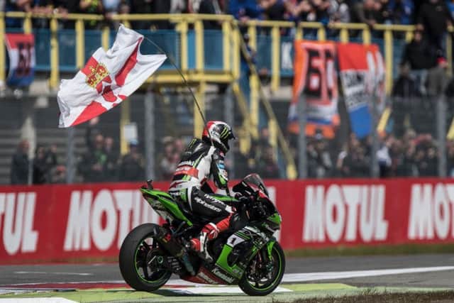 Jonathan Rea celebrates with a Northern Ireland flag at Assen.