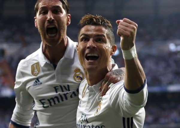 Cristiano Ronaldo celebrates with Real Madrid's Sergio Ramos after scoring the opening goal during the Champions League semi-final first leg. AP Photo/Daniel Ochoa de Olza