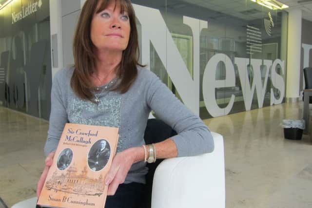 Susan B Cunningham with her book about Sir Crawford McCullagh, pictured in the News Letter's Belfast offices