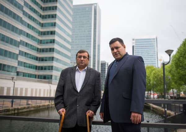 Ihsan Bashir (left) with the head of the Docklands victims' campaign group Jonathan Ganesh, in Docklands, in east London.