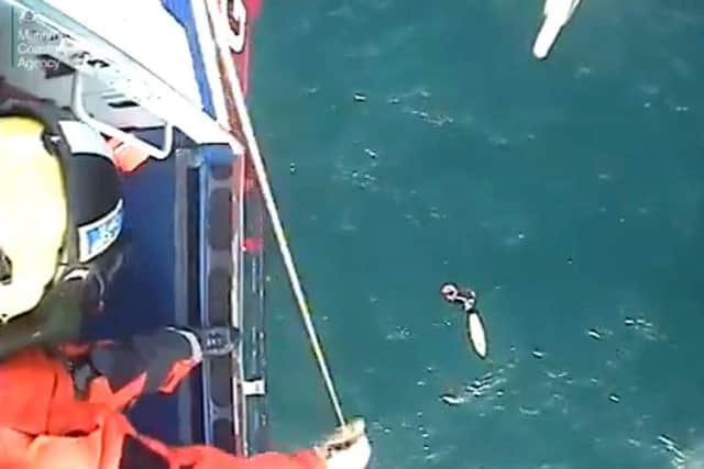 Screen grabbed image taken from video issued by the Maritime & Coastguard Agency of the moment surfer Matthew Bryce, who survived more than 30 hours stranded at sea on his board, was rescued