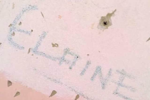 Elaine's name, which was etched on her old bedroom wall shortly before she was killed.
