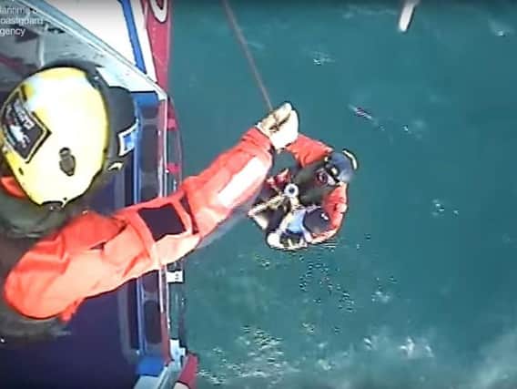 Screen grabbed image taken from video issued by the Maritime & Coastguard Agency of the moment surfer Matthew Bryce, who survived more than 30 hours stranded at sea on his board, was rescued.