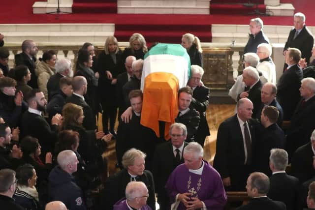 The Tricolour-draped coffin of Martin McGuinness is carried out of at St Columba's Church Long Tower, in Londonderry following his funeral service in March 2017.  Photo: Niall Carson/PA Wire