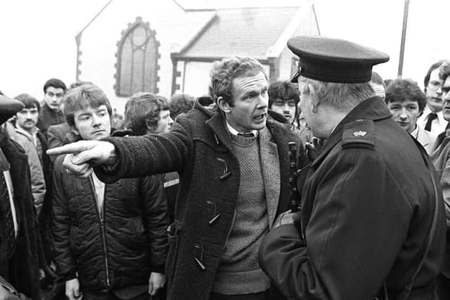Martin McGuinness remonstrating with police to get their men out of the cemetery at the funeral of IRA man Henry Hogan at Dunloy, Co Antrim in 1984.  Picture by Pacemaker Press Intl