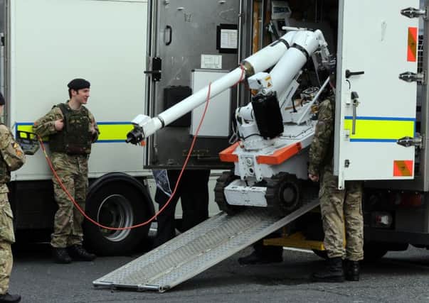 Army bomb disposal experts at the scene in north Belfast after a double pipe bomb attack on the police in May 2013