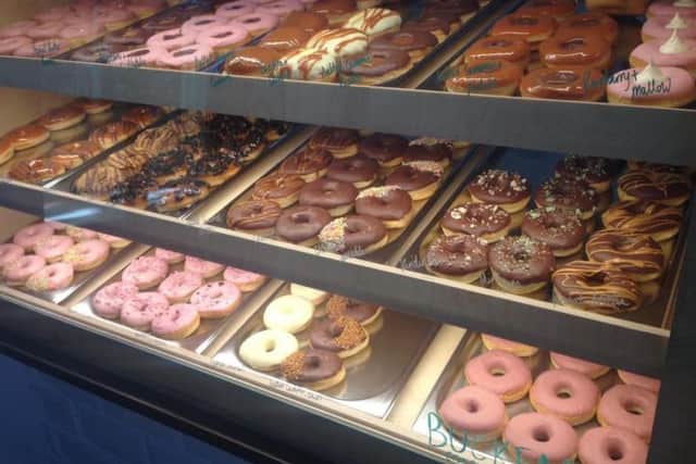 There can be anything up to 36 varieties of doughnuts on display on a busy day at the cafe in Smithfield (Credit: Doughzy Donuts).