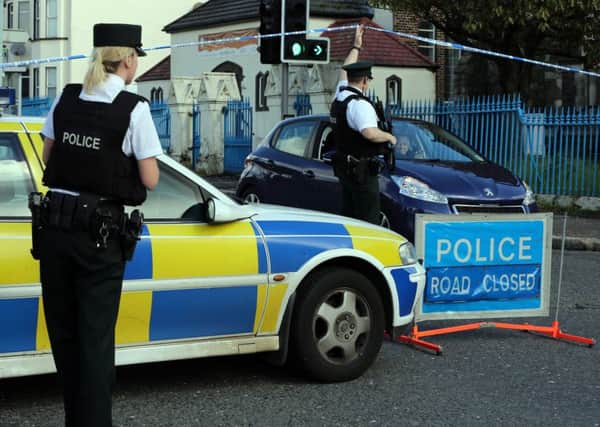 Armed police seal off an area in north Belfast after a double pipe bomb attack on the police on May 28, 2013. The officers were targeted while responding to an emergency call in the Crumlin Road area during the early hours of the morning.