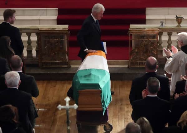 Former US President Bill Clinton touches the coffin during the funeral of Northern Ireland's former deputy first minister and ex-IRA commander Martin McGuinness at St Columba's Church Long Tower, in Londonderry. The Americans execute terrorists, says Shane Paul O'Doherty. Photo: Niall Carson/PA Wire