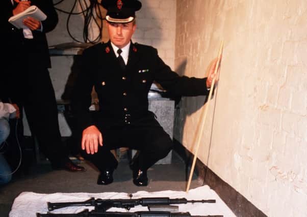 Chief Superintendent Harry Breen shows the guns the eight IRA men were carrying when they were shot dead by the SAS at Loughgall