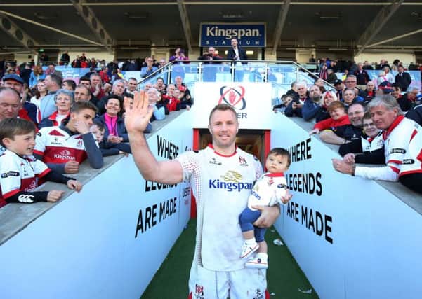 Roger Wilson with his 10-month old son Nico waves to the crowd at the Kingspan Stadium