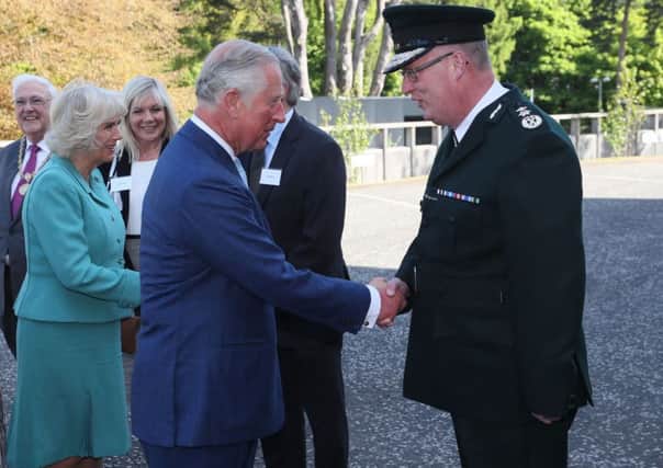 Police Service of Northern Ireland Chief Constable George Hamilton  greets the Prince of Wales as he attends the PSNI HQ memorial garden opening in Belfast, during their visit to Northern Ireland