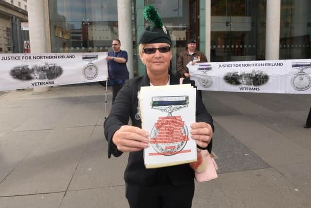 Angela Barnes joins protesters who gather outside the courts in Belfast city centre on Wednesday, to protest against  servicemen who face chargesrelating to The Troubles.