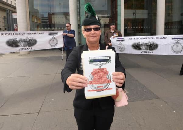 Angela Barnes joins protesters who gather outside the courts in Belfast city centre on Wednesday, to protest against  servicemen who face chargesrelating to The Troubles.
