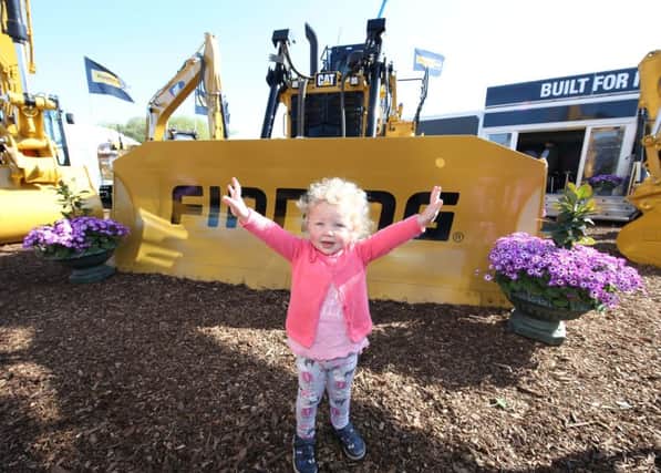 PressEye-Northern Ireland- 9th May  2017-Picture by Brian Little/PressEye

Caoimhe Brady  aged 2 from Donaghmore  surrounded by a CAT Track Type Tractor weighing 21,715 kg, during Day One, Balmoral Show 2017, in partnership with Ulster Bank, at Balmoral Park.
Picture by Brian Little / PressEye