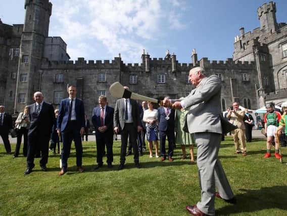 The Prince of Wales tries his hand at hurling as he and the Duchess of Cornwall visit Kilkenny Castle