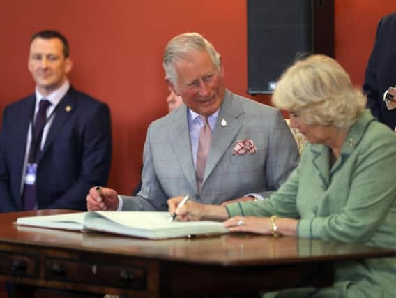The Prince of Wales at the Duchess of Cornwall signing the visitors book in Kilkenny Castle