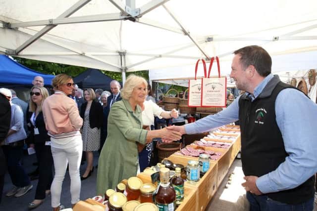 The Duchess of Cornwall looks at food stalls during he visit to Kilkenny Castle.