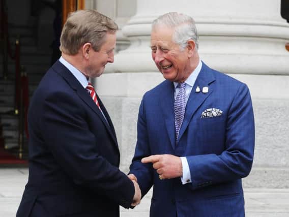 The Prince of Wales (left) is greeted by Taoiseach Enda Kenny as he arrives at Government Buildings, Dublin in the Republic of Ireland.