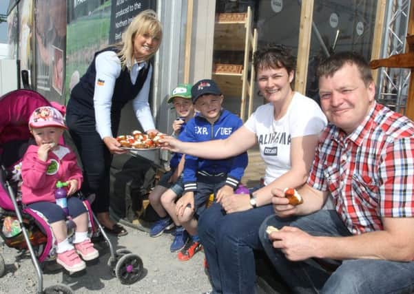 Martina from Skea Eggs hands out some treats to Neil and Jennifer Walker and their children Jennifer, James, Lewis and Lilly.