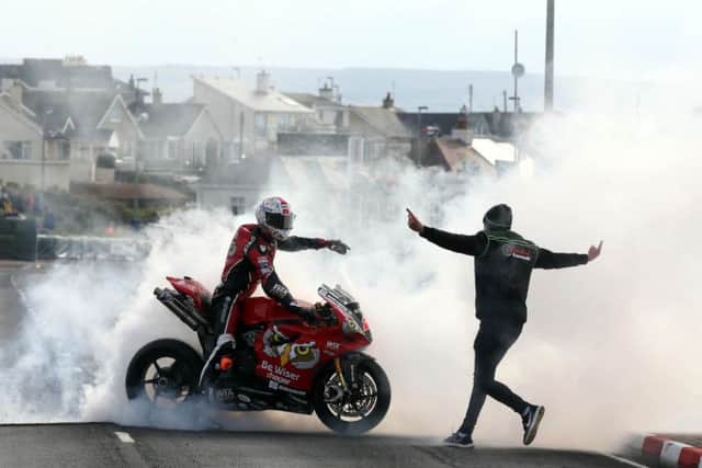 NW200 Superbike winner Glenn Irwin is greeted by his jubilant brother Andrew at the end of the race.