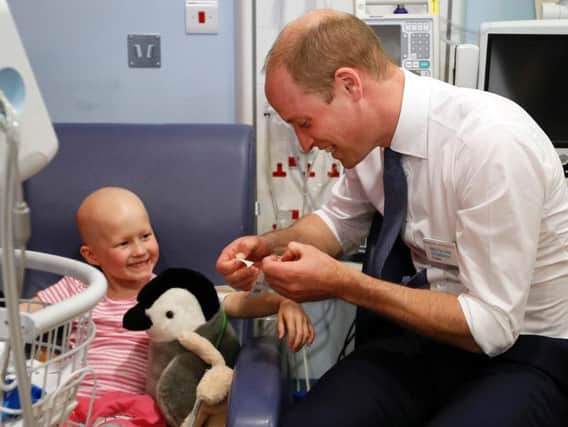 The Duke of Cambridge meets patient Daisy Wood, 6, during a visit to the Royal Marsden NHS Foundation Trust in Sutton, Surrey, marking 10 years since he became president of the centre.
