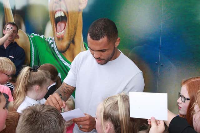 The Charlton Athletic forward signs autographs for local schoolchildren