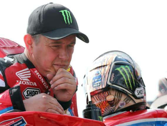John McGuinness remains in the Royal Victoria Hospital in Belfast following his crash at the North West 200.