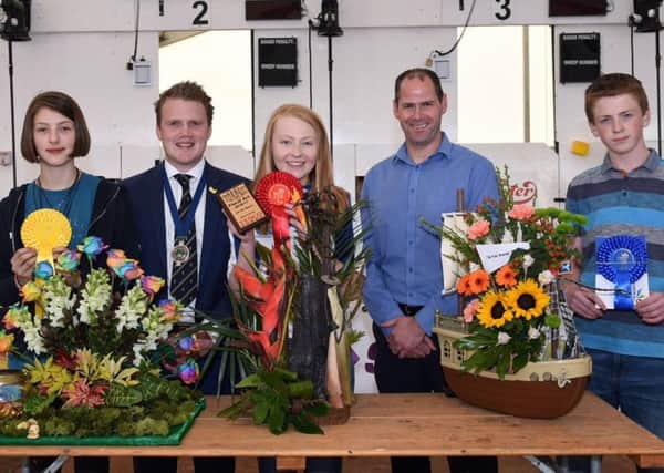 Pictured are the 12-14 age category winners in the YFCU floral art competition. From left-right: Third place winner, Erin Warden, Newtownards YFC, YFCU president James Speers, first place winner, Emma Mills, Randalstown YFC, Stephen McGill, commercial manager from sponsor, Tesco NI, and second place winner, James Johnston from Kesh YFC