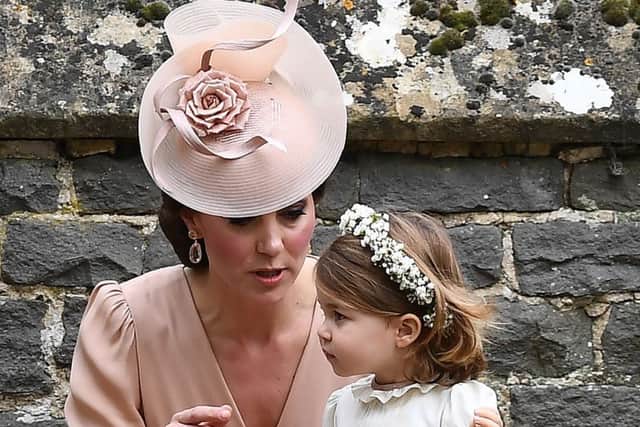The Duchess of Cambridge with her daughter Princess Charlotte outside St Mark's church in Englefield, Berkshire, following the wedding of Pippa Middleton and James Matthews. PRESS ASSOCIATION Photo. Picture date: Saturday May 20, 2017. See PA story ROYAL Pippa. Photo credit should read: Justin Tallis/PA Wire