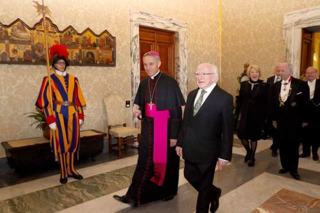 Handout photo issued by Maxwell Photography of His Grace Archbishop Georg Ganswein greeting Irish President Michael D Higgins to the Vatican City