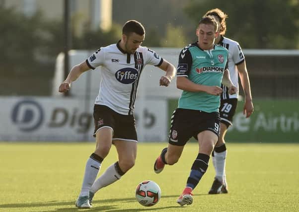 Dundalk's Michael Duffy shields the ball from Derry City winger Ronan Curtis.