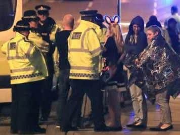 Police and concert-goers outside Manchester Arena