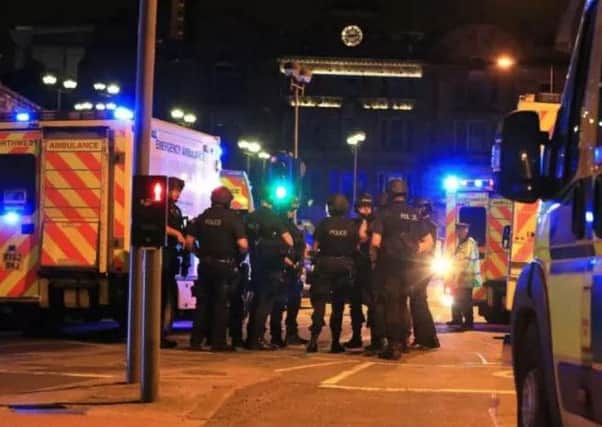 Armed police at Manchester Arena after reports of an explosion at the venue during an Ariana Grande gig. Photo: PA