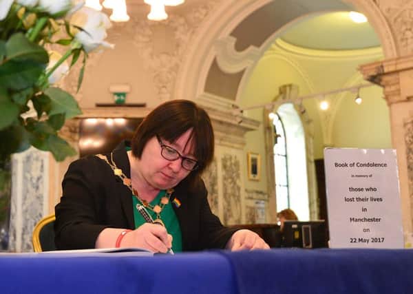 Deputy Lord Mayor councillor Mary Ellen Campbell pictured signing a book of condolences, opened up for the victims of last night's bomb attack in Manchester