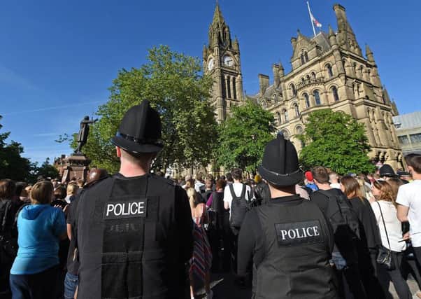 People gather for a vigil in Albert Square outside Manchester Town Hall